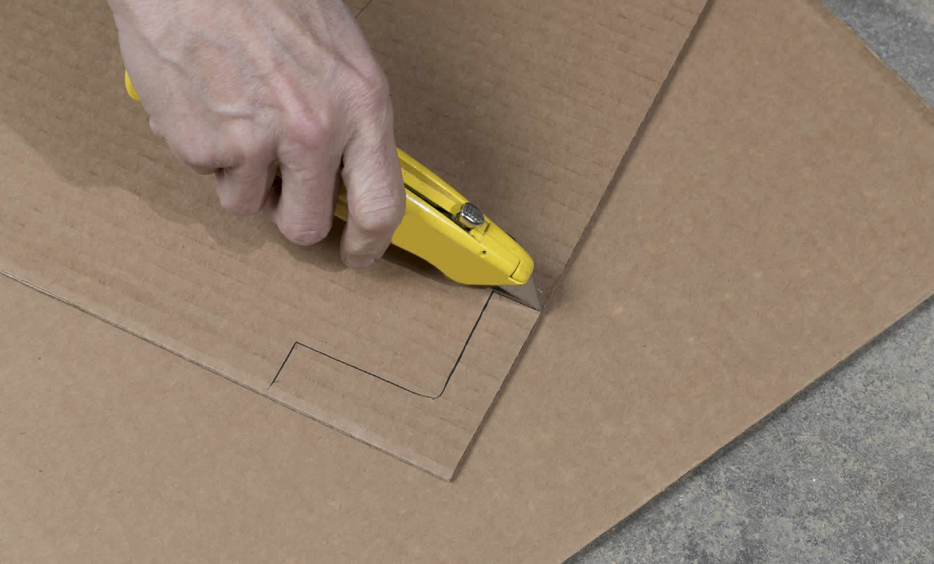 cutting cardboard with a box cutter
